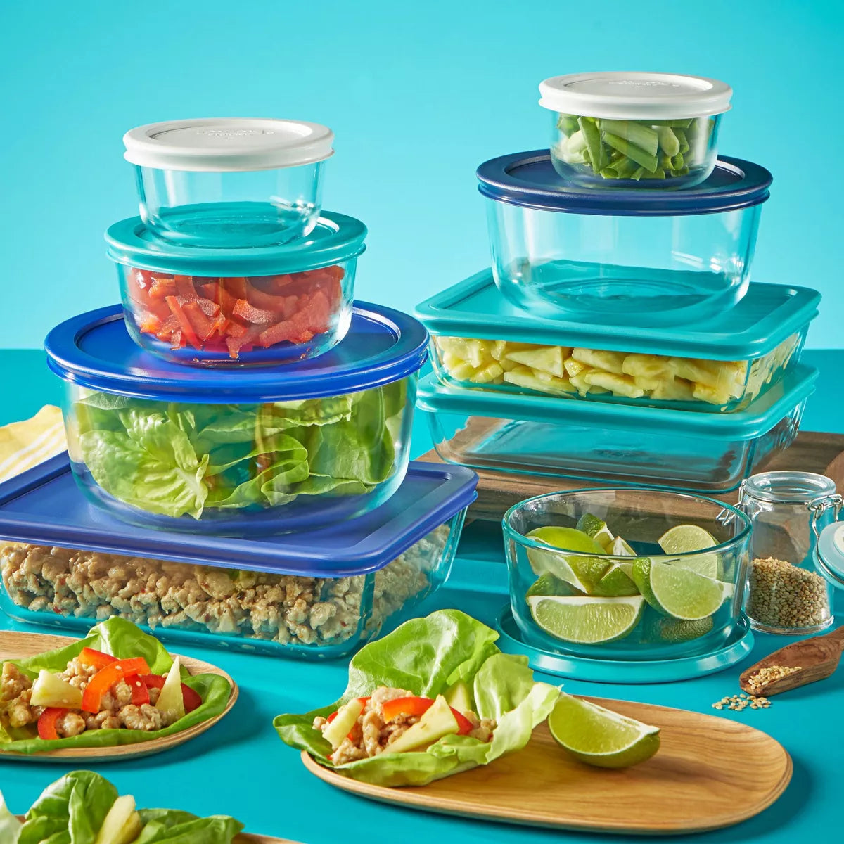 Set of Pyrex 18-piece glass storage containers with lids, featuring transparent glass and colorful accents, by X With Love.