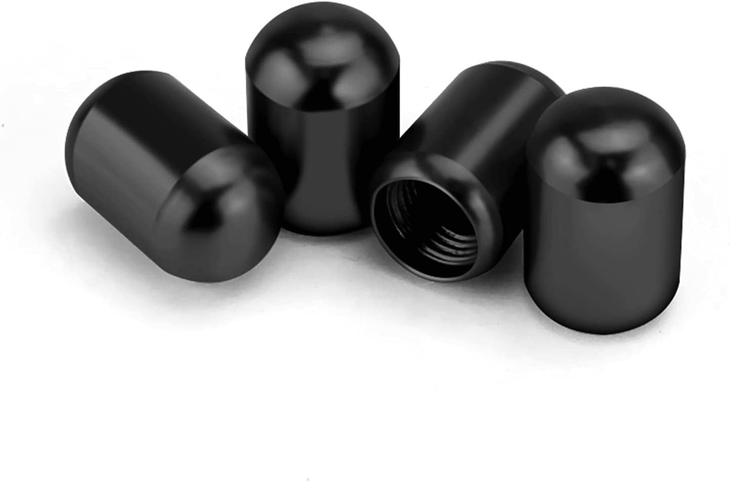 Black 4-pack car tire valve stem caps on wheels, universal air caps cover for cars, SUVs, bikes, trucks, and motorcycles.