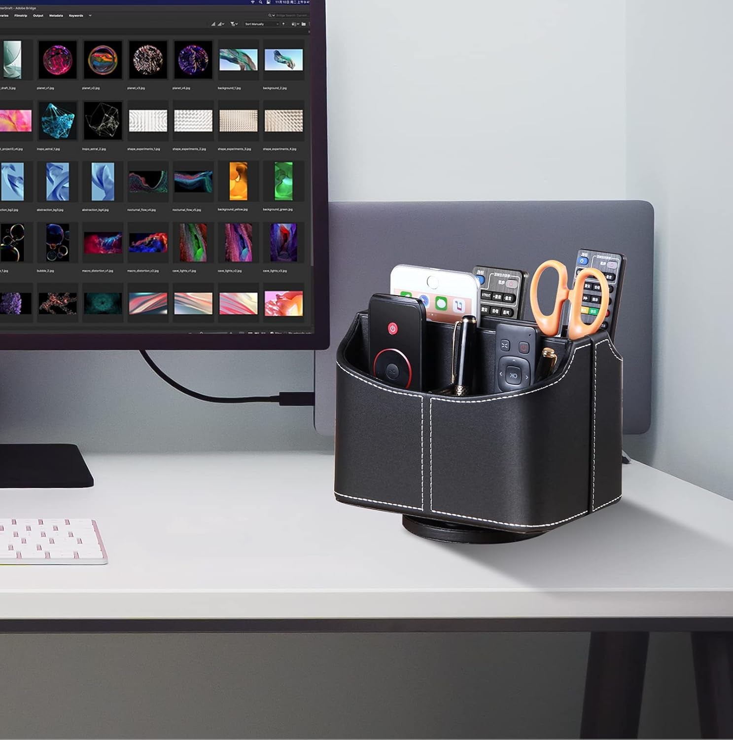 Leather remote control holder with 360-degree spinning design, organizing TV remotes, mobile phones, pens, and more on a bedside table.