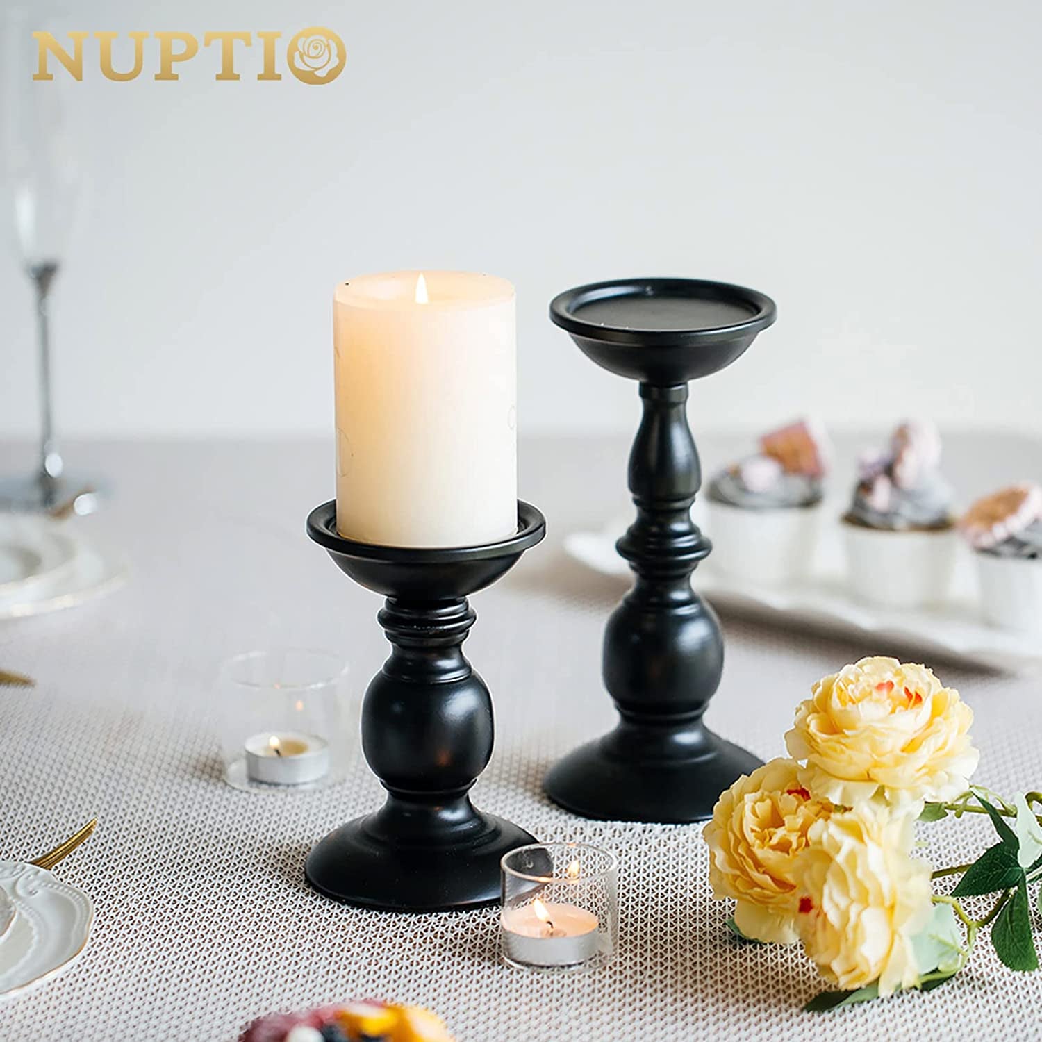 Set of two black metal candle holders for pillar candles, featuring a rustic, tall design ideal for farmhouse or fall home decor.