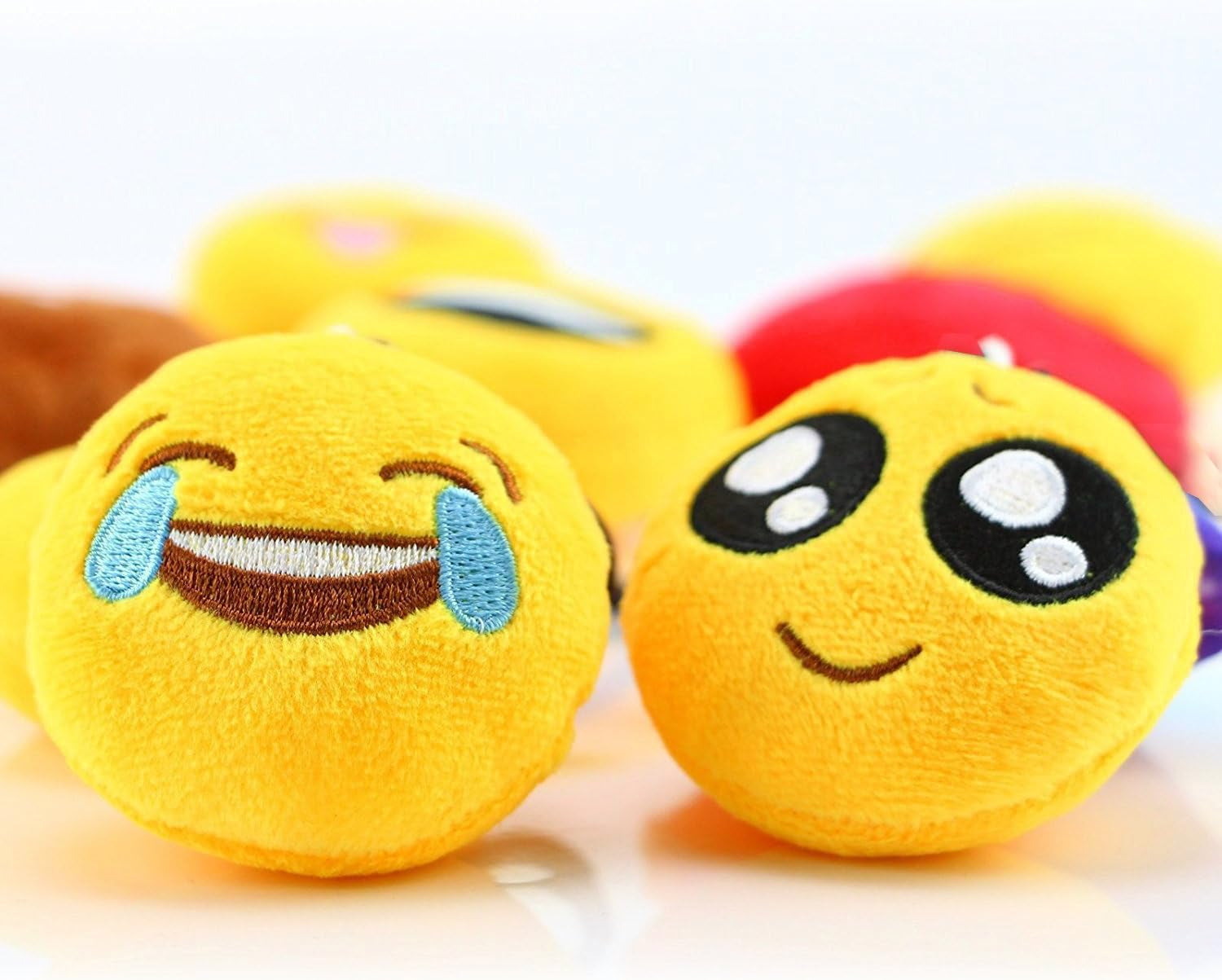 Set of 30 colorful 2-inch emoticon plush keychains featuring fun facial expressions, ideal as party favors and Easter egg fillers.