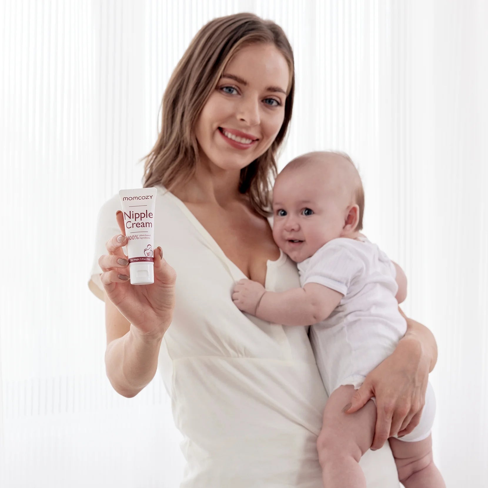 Two tubes of X With Love 100% natural nipple cream, vegan, lanolin-free, for breastfeeding, with breastfeeding pump in the background.