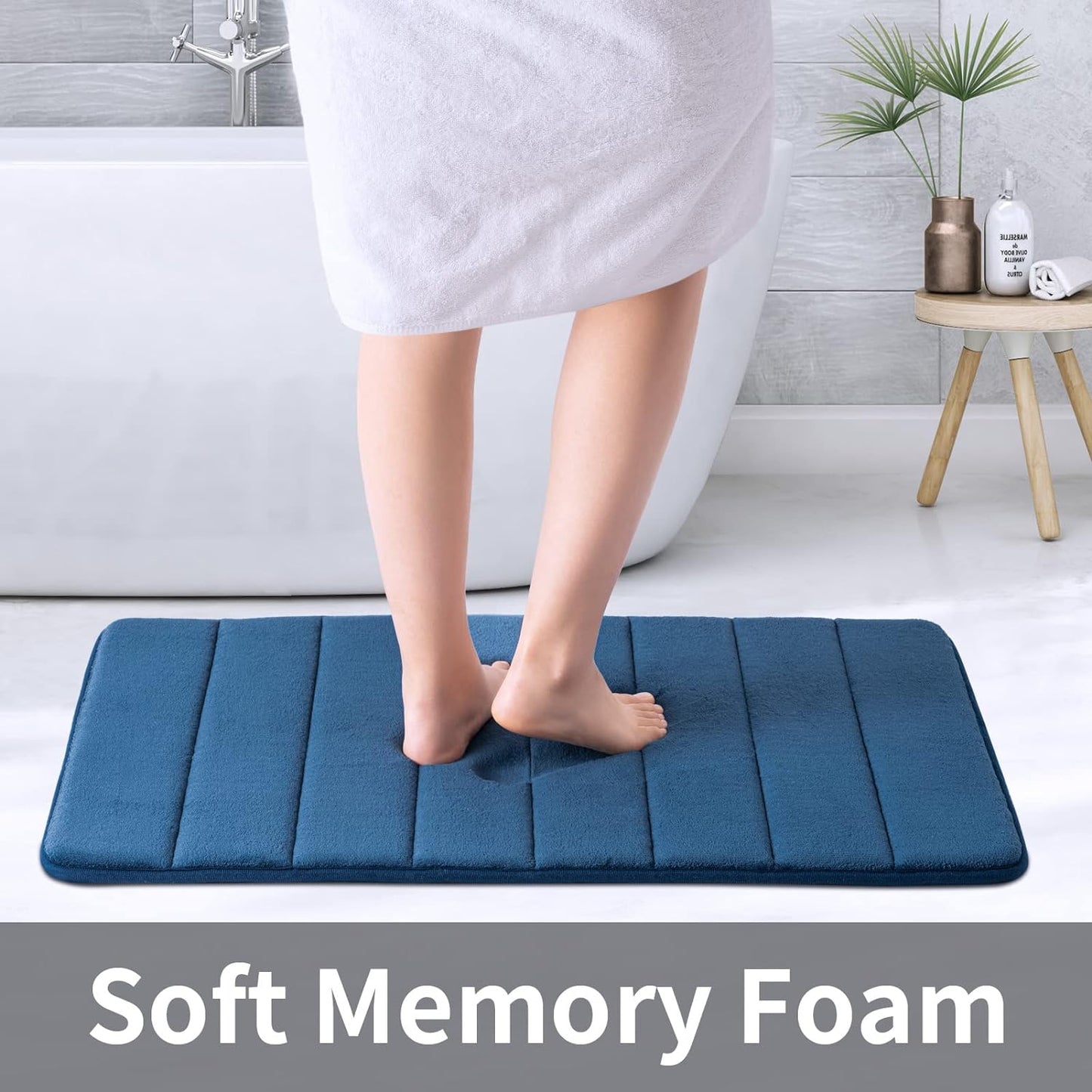 Navy memory foam bath mat measuring 20x32 inches with water absorbent surface, non-slip PVC backing, ultra soft for bathroom floor.