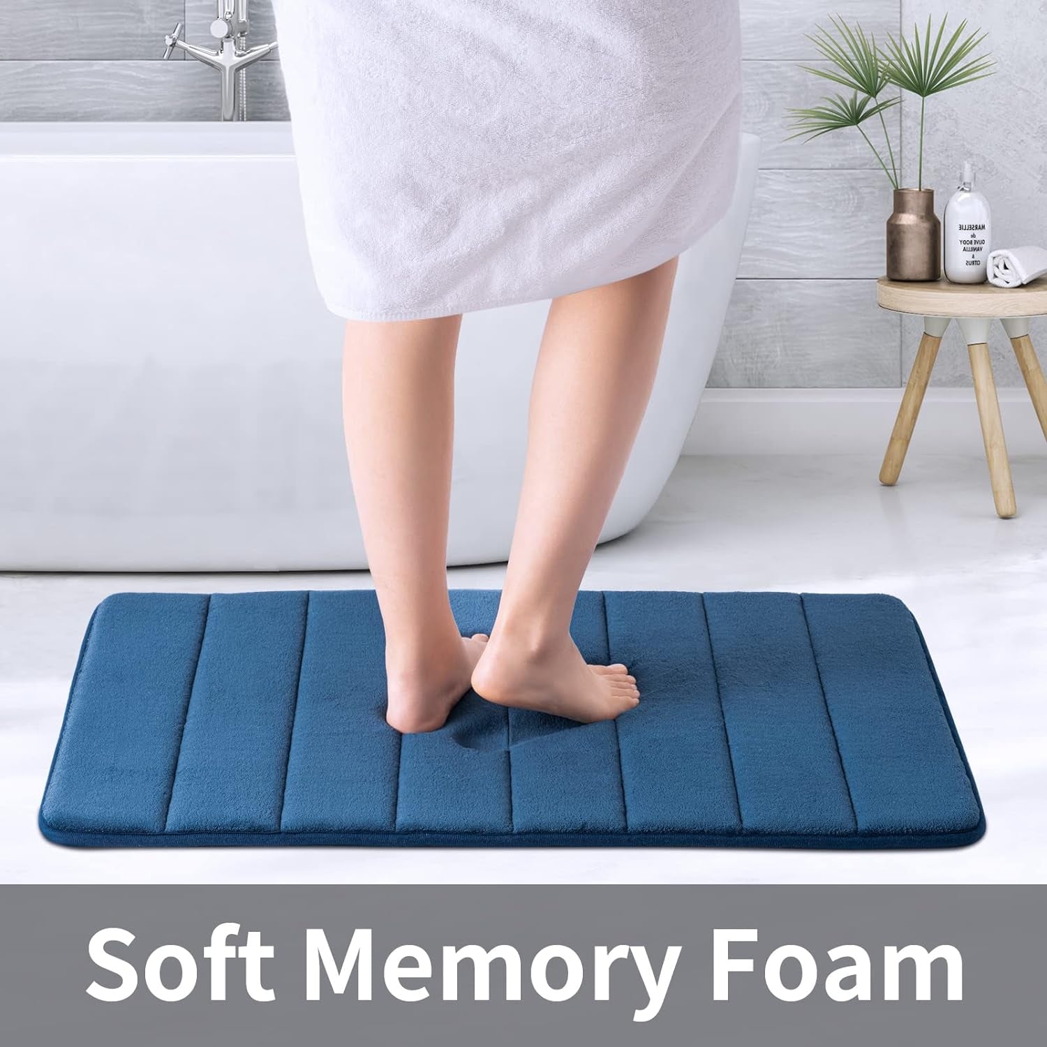 Navy memory foam bath mat measuring 20x32 inches with water absorbent surface, non-slip PVC backing, ultra soft for bathroom floor.