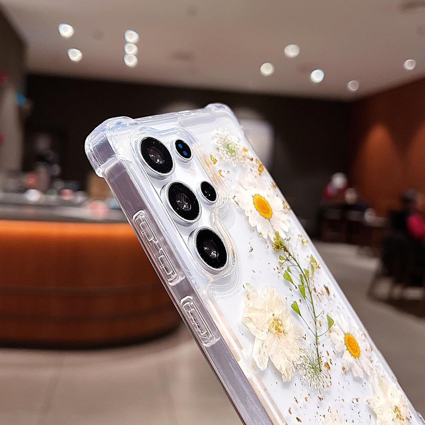 Clear Samsung Galaxy S26 Ultra case with pressed dried real flowers, glitter accents, shockproof design, and white floral pattern.