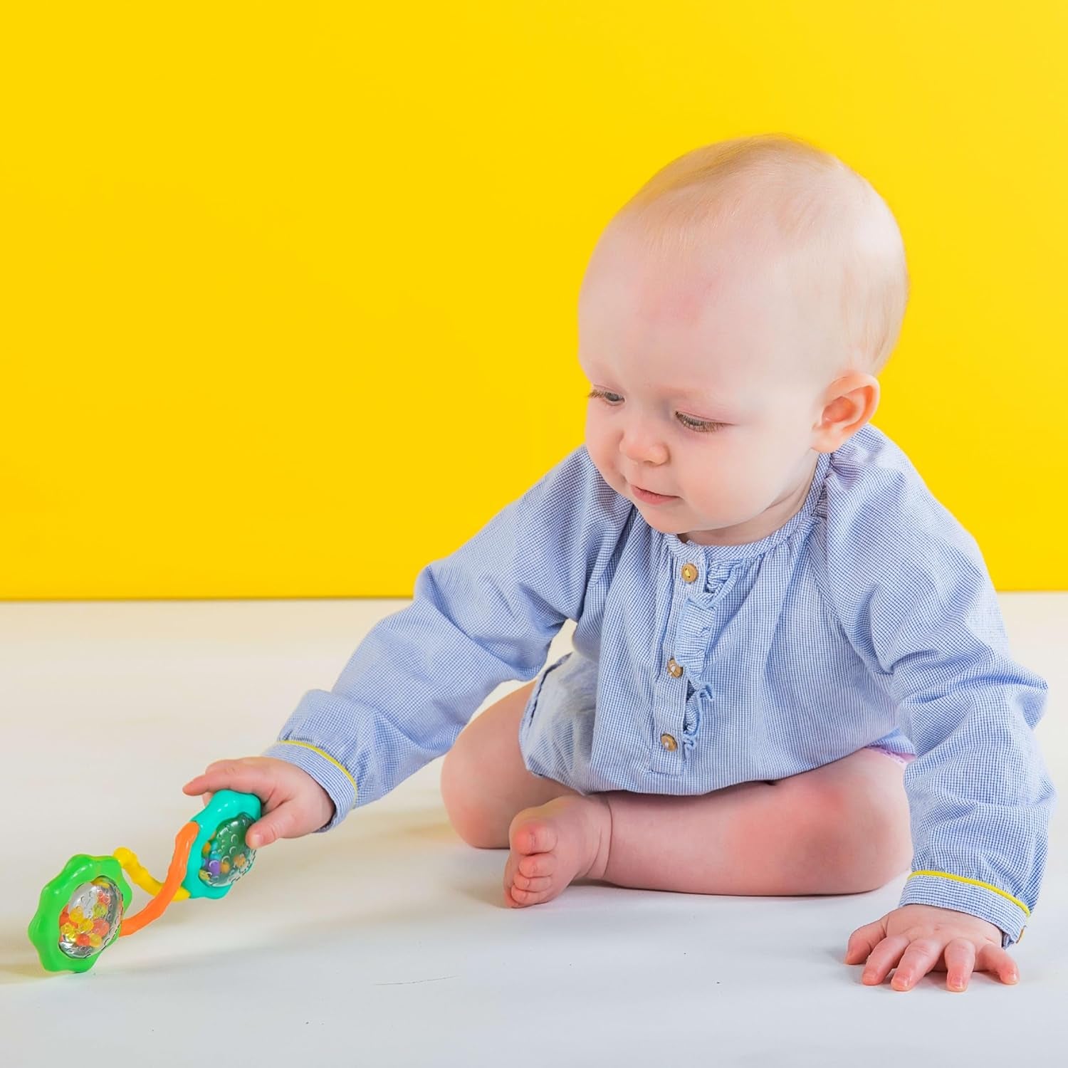 Green Rattle & Shake Barbell toy for babies ages 3 months and up, designed for early play and sensory development.