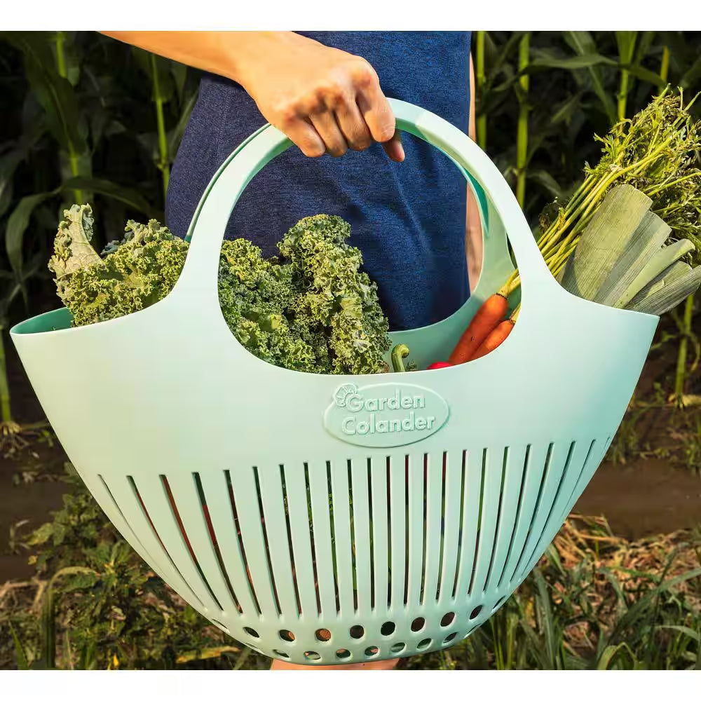 Pink garden colander harvest basket by X With Love, showing a metal strainer with a pink handle and woven design for collecting produce.