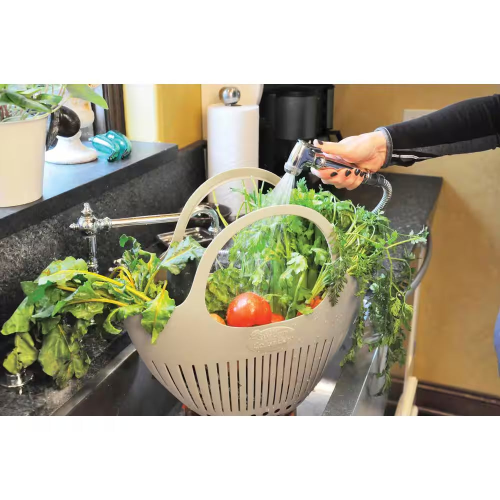 Pink garden colander harvest basket by X With Love, showing a perforated metal basket with a pink finish for gathering garden produce.