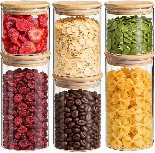Set of six X With Love glass storage containers with airtight lids, labeled, for pantry organization and storing dry food and snacks.