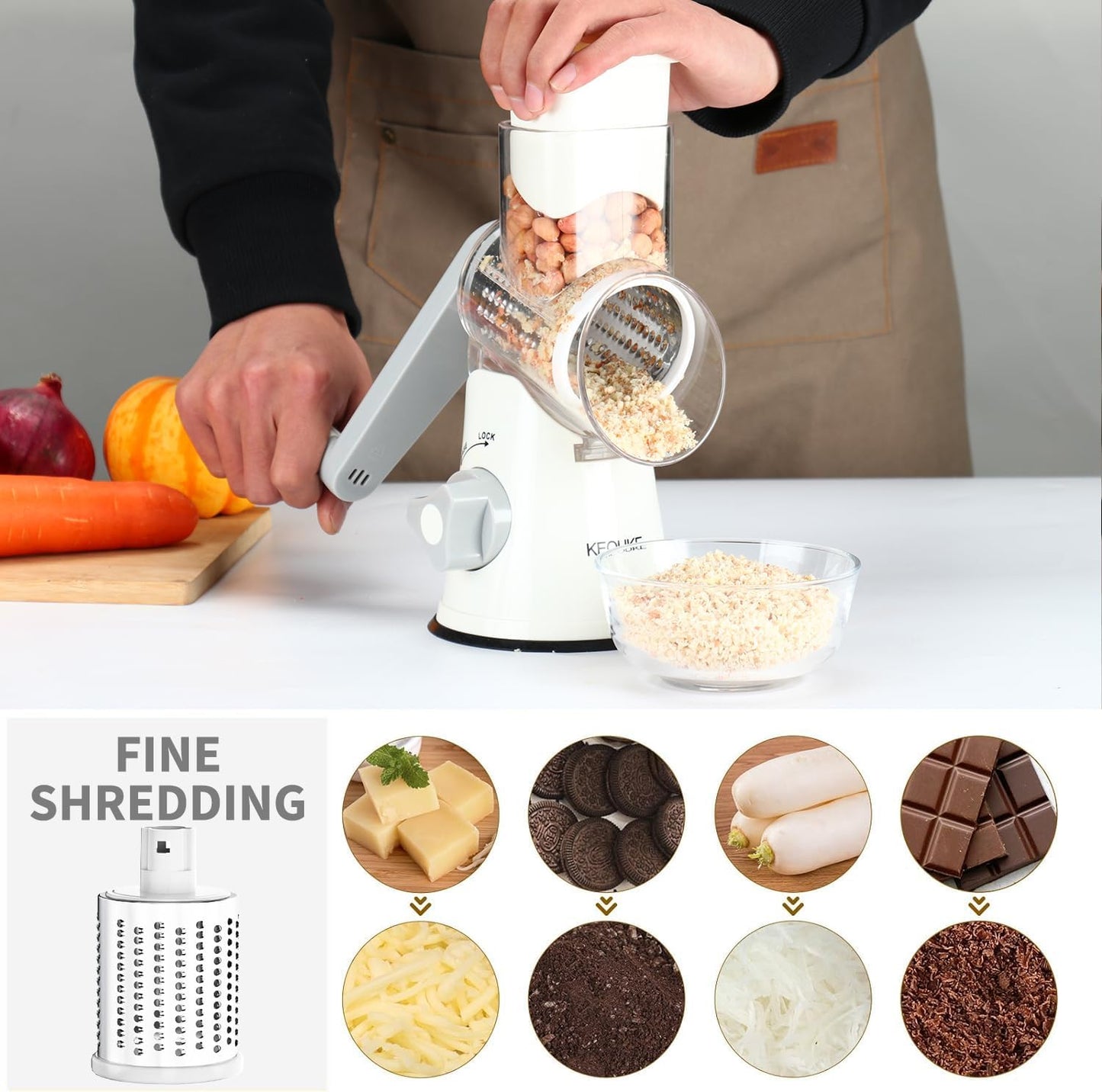 White rotary cheese grater with hand crank, three blades, non-slip suction base for shredding cheese, vegetables, and nuts.