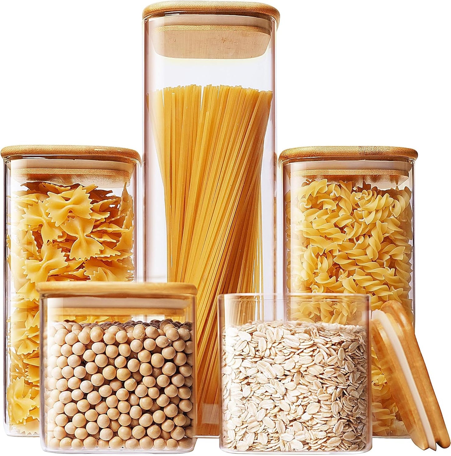 Set of five square glass jars with bamboo lids for kitchen storage, ideal for pasta, cereal, flour, and sugar.