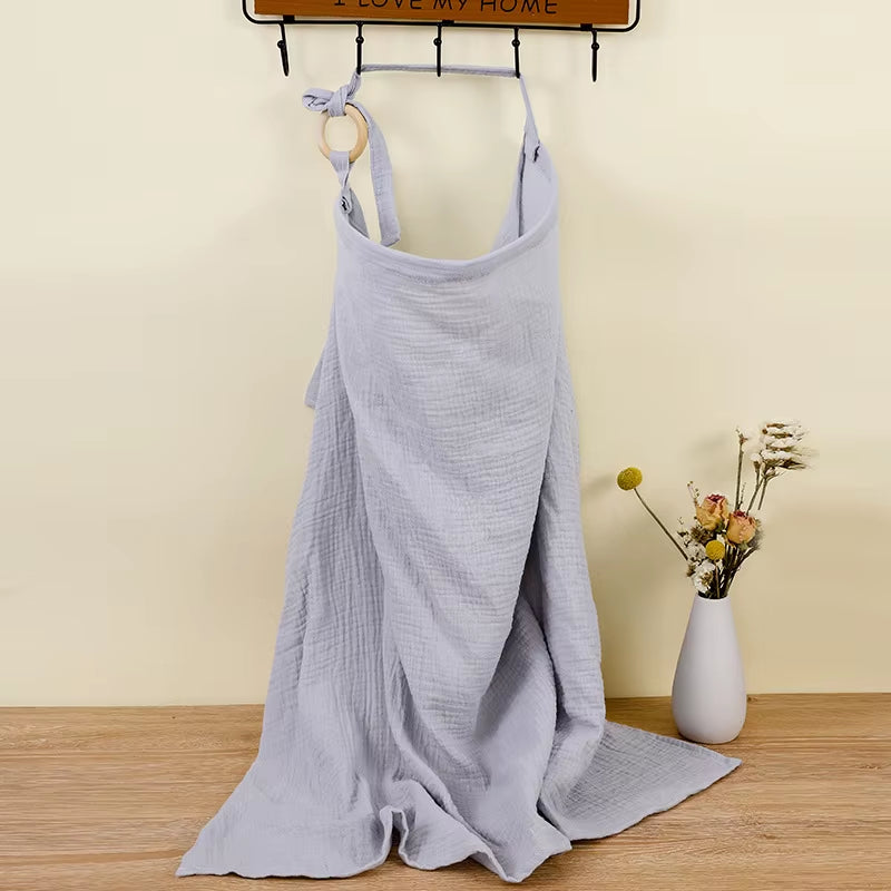 Breathable cotton baby nursing cover by X With Love, showing a soft muslin breastfeeding blanket with a privacy apron for moms.