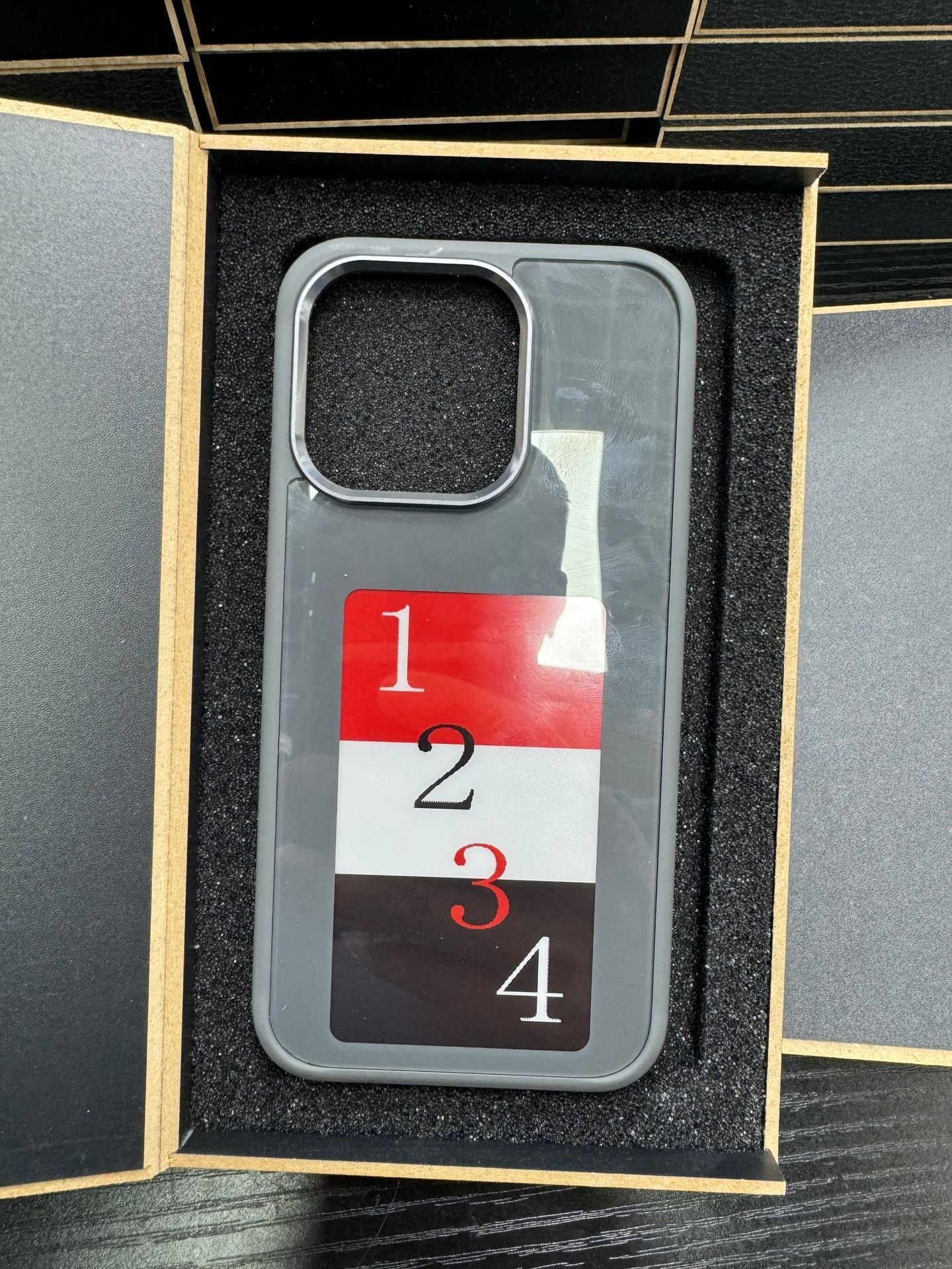X With Love E-Ink screen phone case showing personalized projection design, slim battery-free luxury phone cover with sleek finish.
