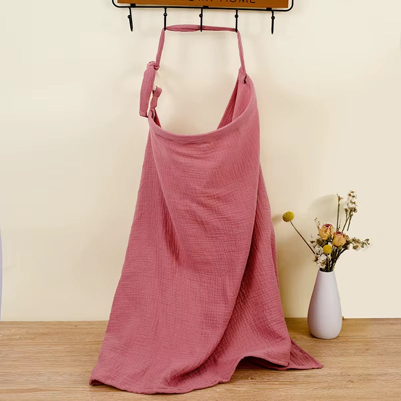 Breathable cotton muslin nursing cover by X With Love, showing a baby feeding under a lightweight maternity breastfeeding apron.