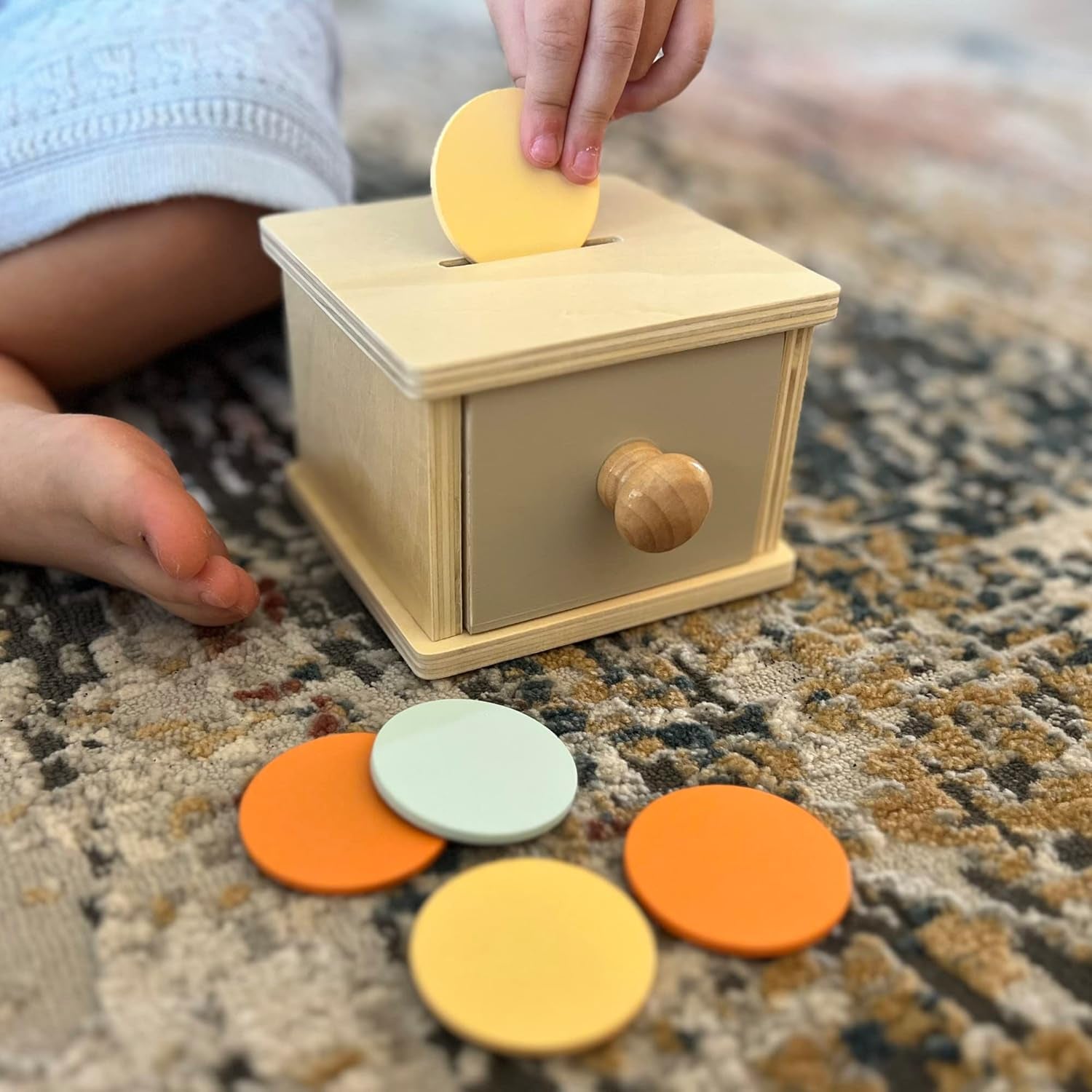 Wooden Montessori coin box toy for 1-year-old toddlers, featuring a baby wooden ball and drawer for object permanence learning.