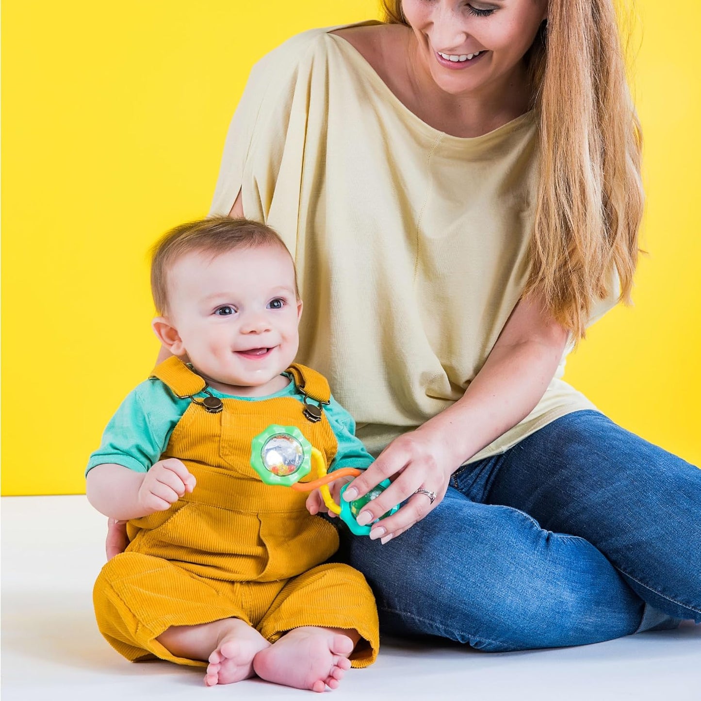 Green Rattle & Shake Barbell toy for babies ages 3 months and up, featuring colorful, easy-to-hold design for early sensory play.