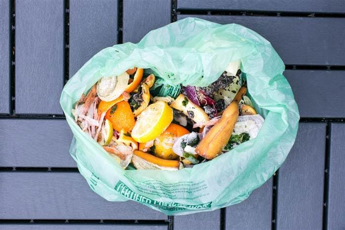 Set of 48 X With Love 13-gallon compostable kitchen trash bags, BPI certified food scrap bin liners made in the USA.